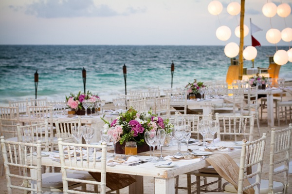 Destination Wedding, beach reception set up, Chivari chairs, white paper lanterns, tiki torches, centerpieces