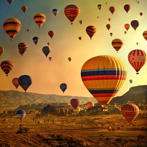 Gorgeous colourful hot air balloons fill the Cappadocia sky for your honeymoon in Turkey