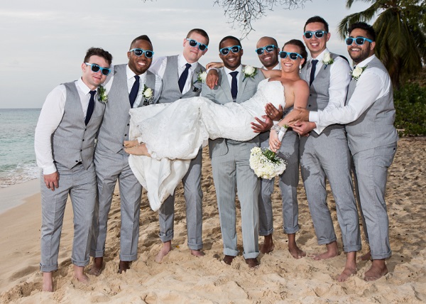groomsmen holding the bride